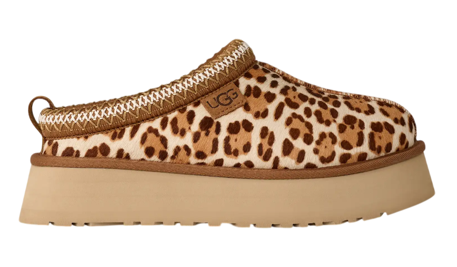 Leopard print slip-on shoe with a beige platform sole on a white background