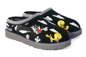 Pair of black slippers with cartoon character design on a white background
