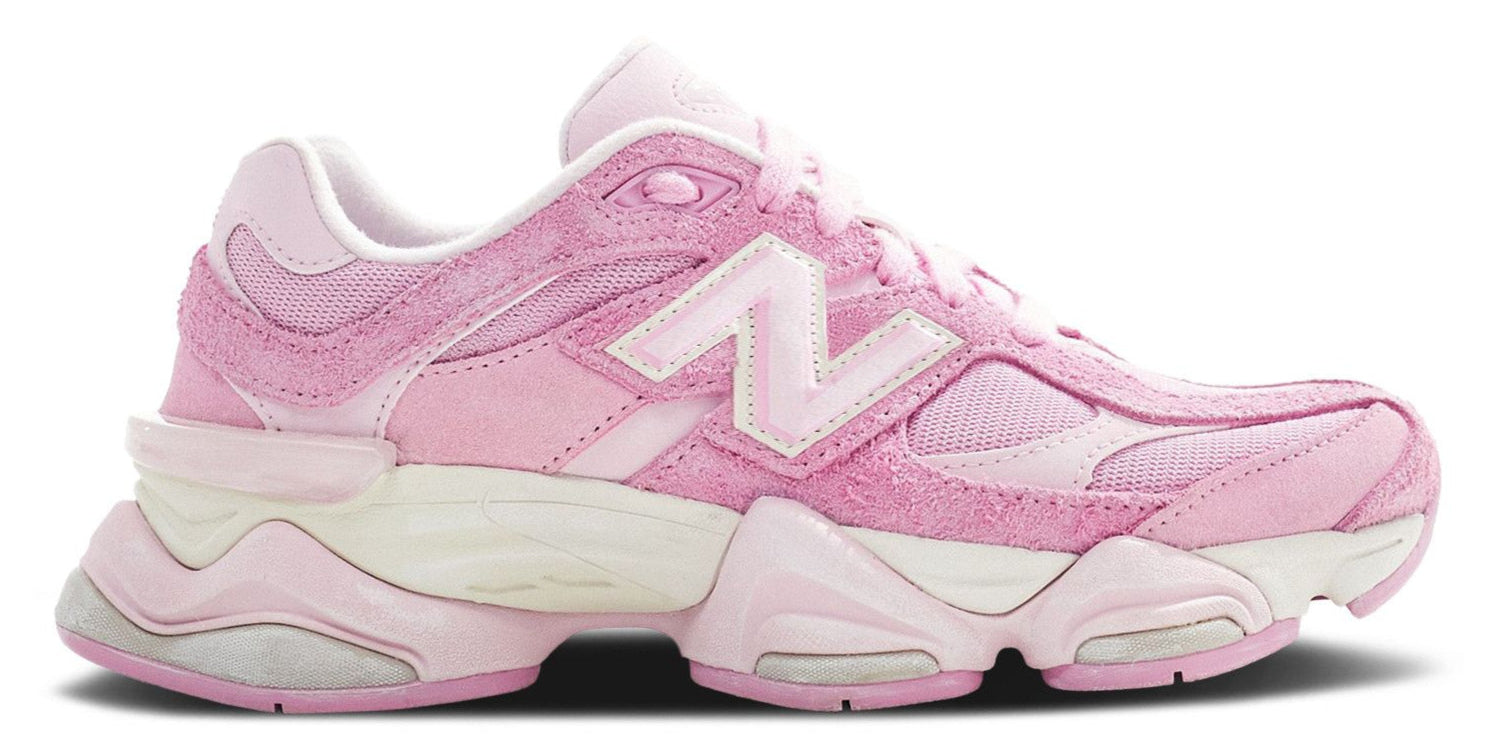 A pair of New Balance 9060 pink overdye sneakers with a mesh upper and a rubber sole.