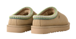 Pair of tan slippers with green trim on a white background - Image 2