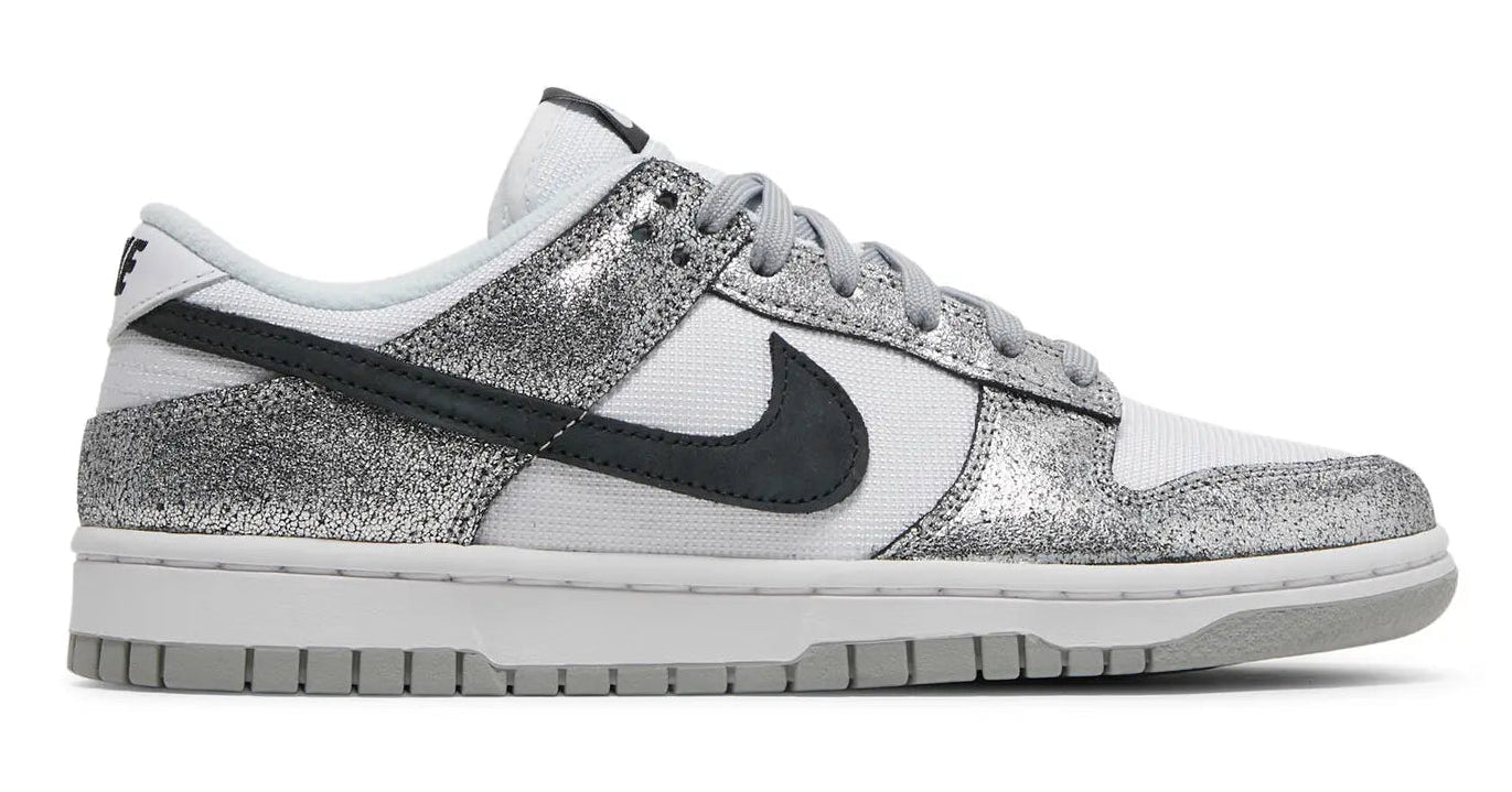 Silver glittery sneaker with black swoosh logo on a white background