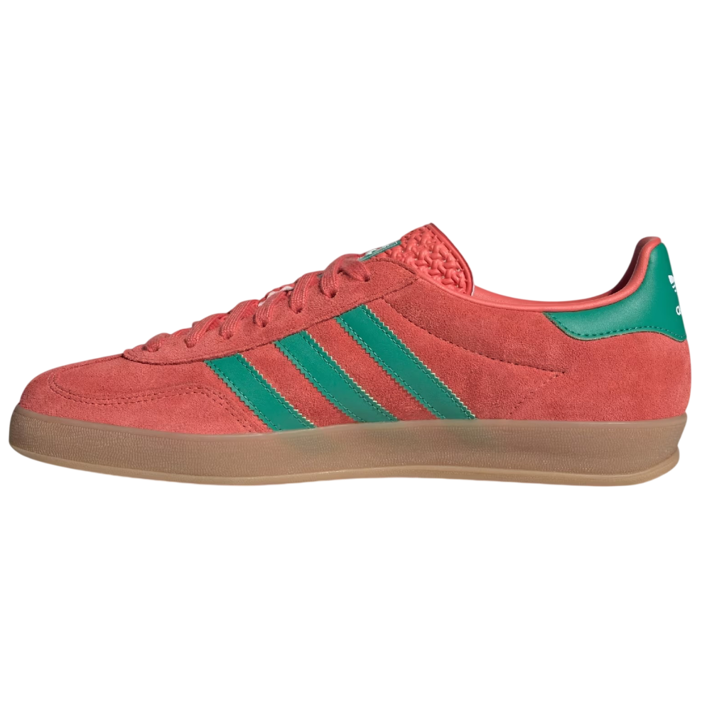 Red Adidas sneaker with green stripes on a white background