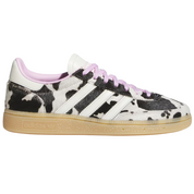 Sneaker with cow print pattern on a white background