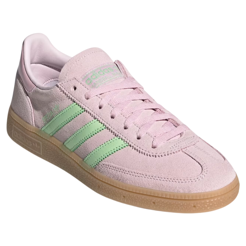 Pink Adidas sneaker with green stripes on a white background