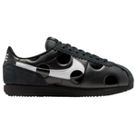 Black sneaker with white accents on a white background - Image 1
