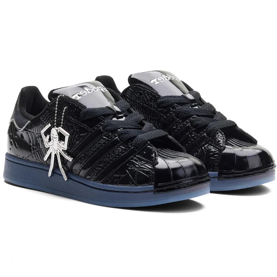 Black sneakers with a spider logo on a white background