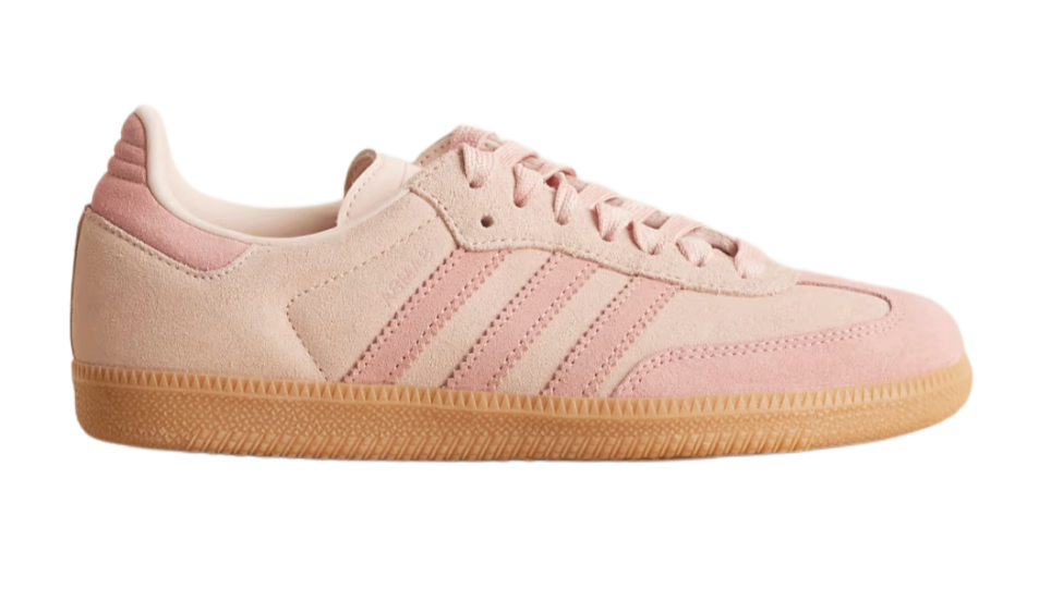 Pink Adidas sneaker with white stripes on a white background