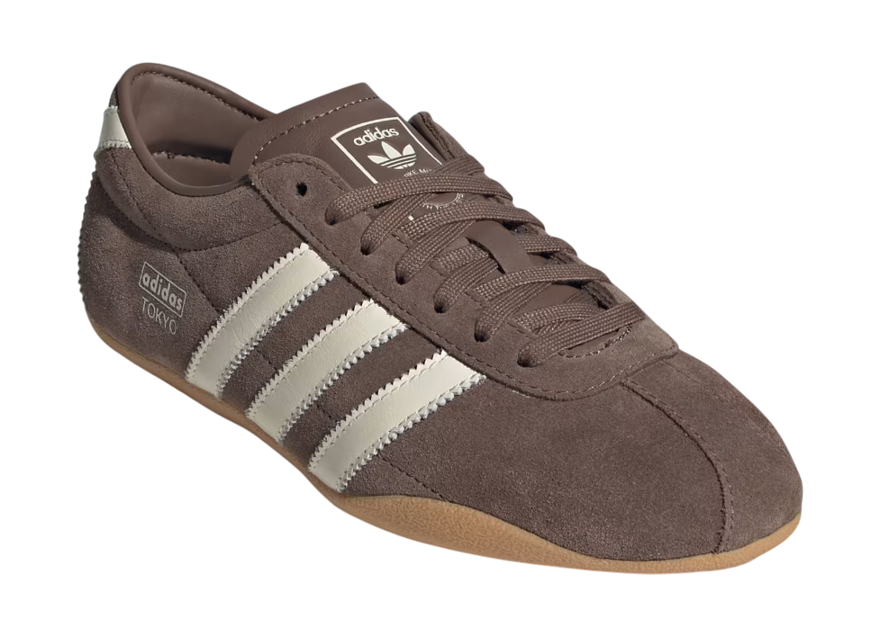 Brown Adidas sneaker with three white stripes on a white background