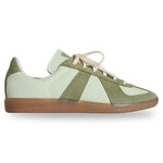 Green and white sneaker with brown sole on a white background - Image 1