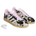 Pair of black and white cow print sneakers with pink laces on a white background - Image 2