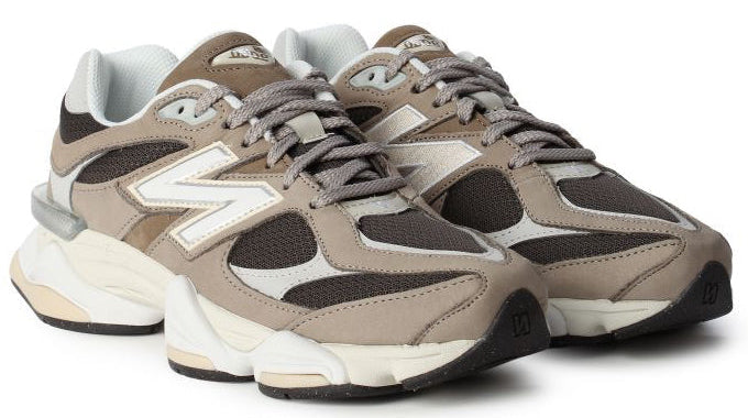 Pair of brown and white sneakers on a white background