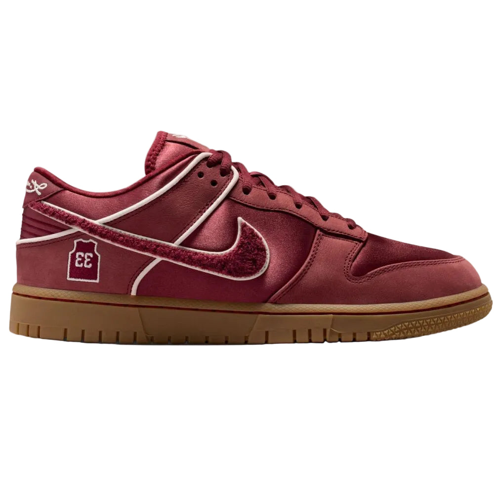 Red sneaker with a brown sole on a white background