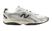 White New Balance sneaker with black logo on a white background