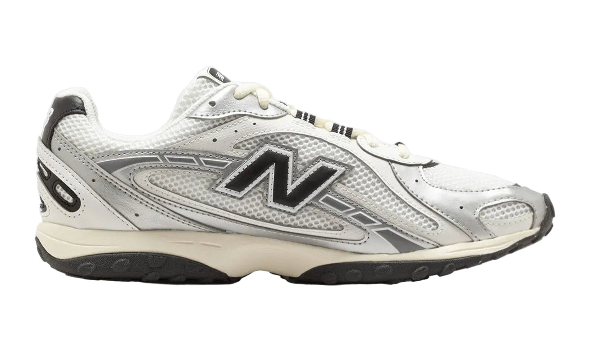 White New Balance sneaker with black logo on a white background