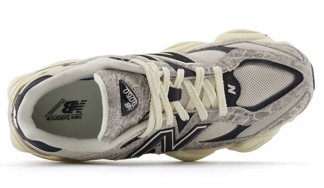 Gray and white sneaker with New Balance logo on a white background
