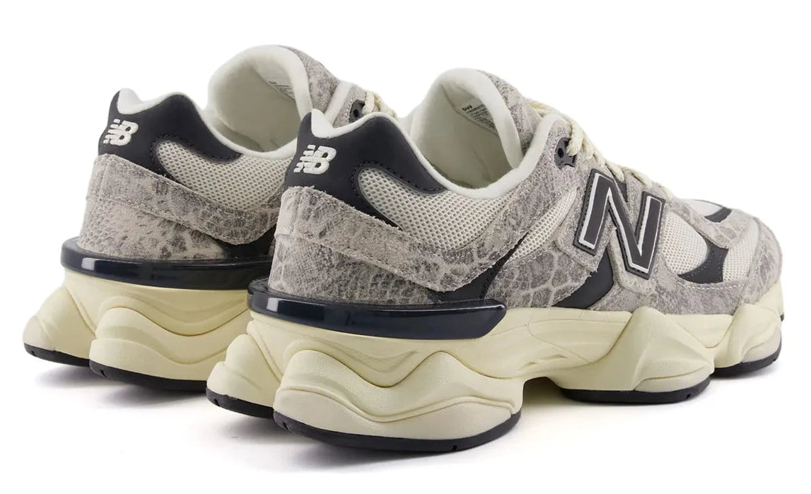 Pair of New Balance sneakers with a snake skin pattern on a white background