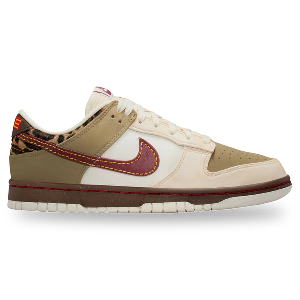 Beige and white sneaker with red accents on a white background