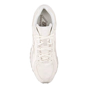 White sneaker with New Balance logo on a light gray background