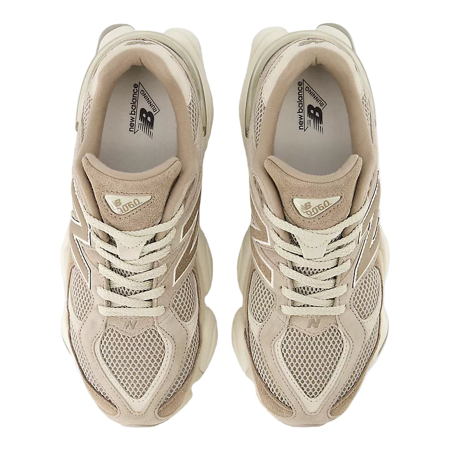 Pair of beige sneakers on a white background