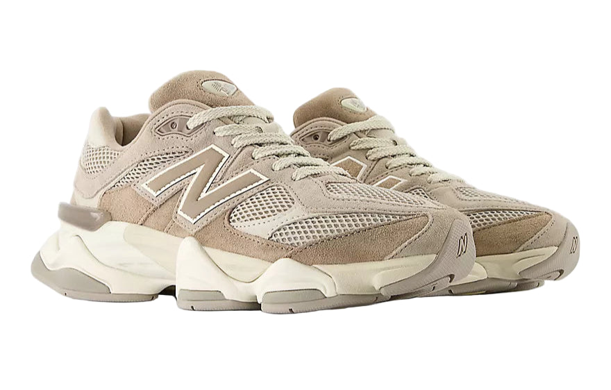 Pair of beige New Balance sneakers on a white background