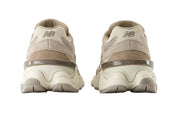 Pair of beige sneakers on a white background